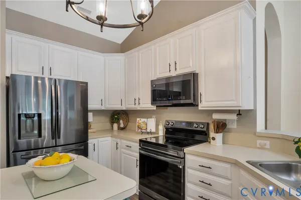 a kitchen with a sink a stove and refrigerator