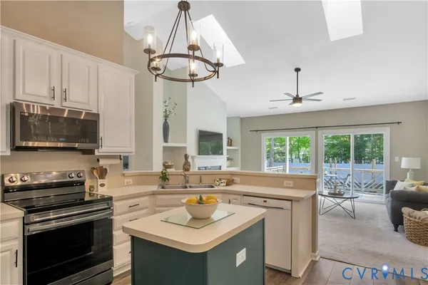 a kitchen with a sink a stove and cabinets