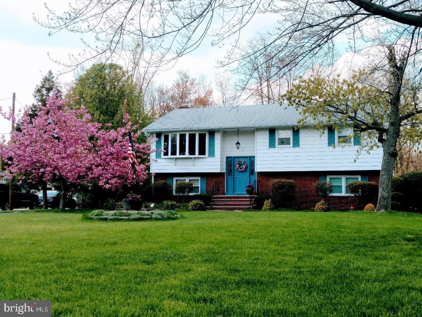 102 Sunset Road Burlington, NJ 08016 - Photo 1 of 18 a front view of a house with a garden and trees
