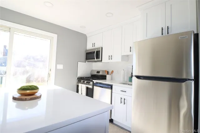 a white refrigerator freezer sitting in a kitchen