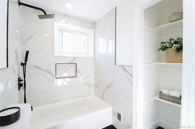 a bathroom with a bathtub and a shower