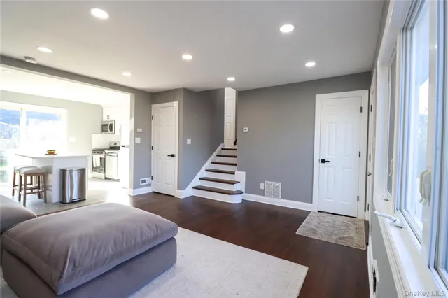 a spacious bedroom with a bed and a large mirror