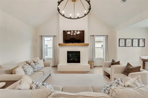 a living room with furniture a fireplace and a flat screen tv