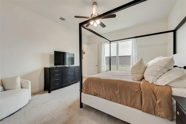 a bedroom with a bed and a flat screen tv