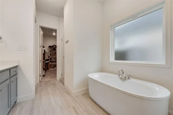 a white bath tub sitting next to a white sink