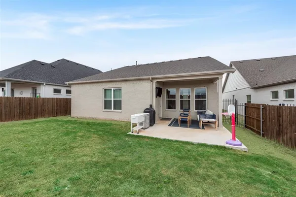 a front view of house with yard and outdoor seating