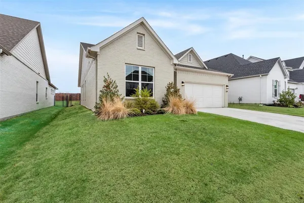 a front view of house with yard and green space
