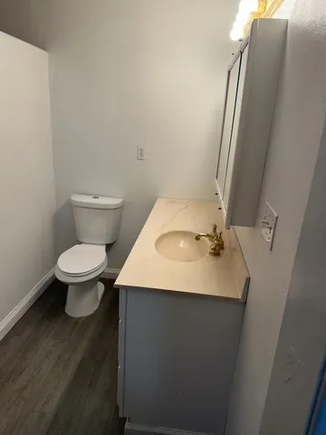 a bathroom with a sink toilet and mirror