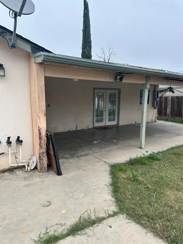 a view of a yard with wooden fence