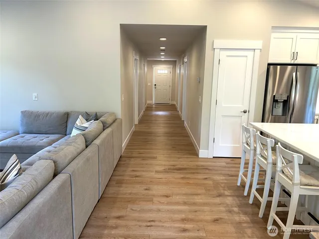 a hallway with wooden floor and furniture
