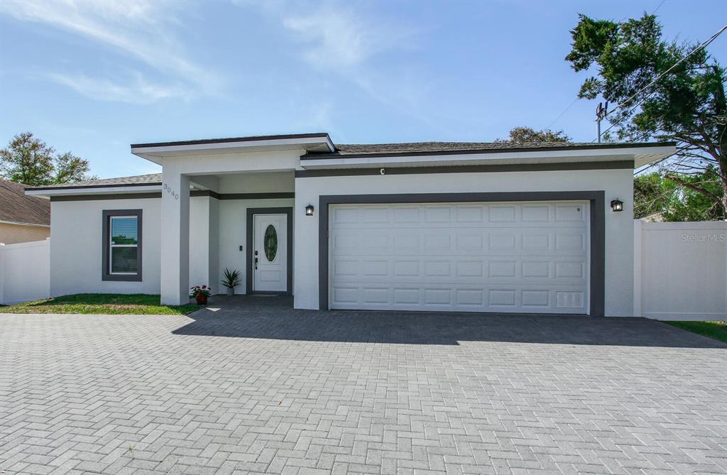3040 Belcher Road Dunedin, FL 34698 - Photo 1 of 24 a front view of a house with a garage