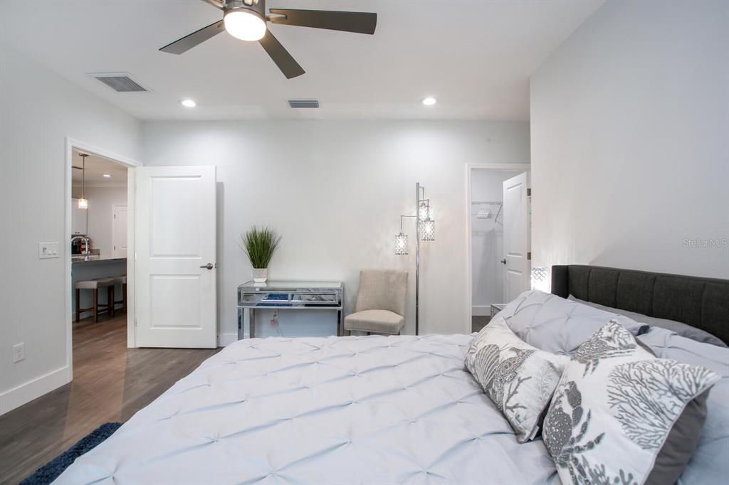 3040 Belcher Road Dunedin, FL 34698 - Photo 13 of 24 a bedroom with a bed and a chandelier