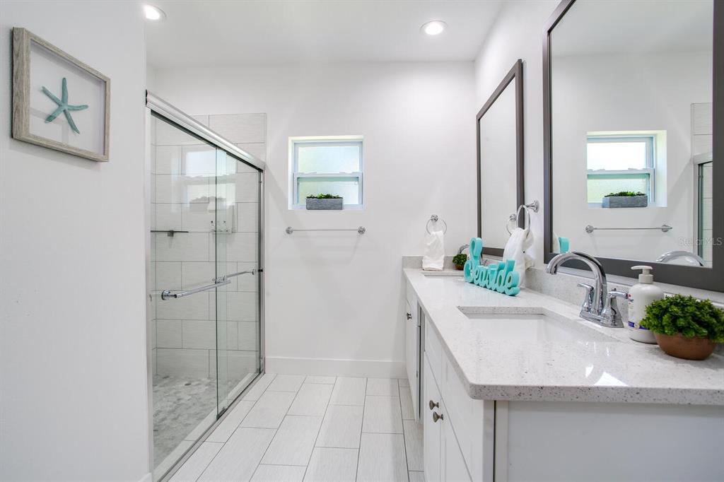 3040 Belcher Road Dunedin, FL 34698 - Photo 14 of 24 a bathroom with a sink and a mirror