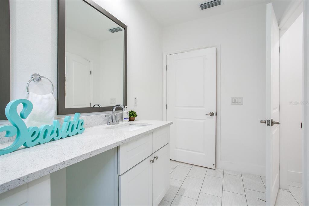 3040 Belcher Road Dunedin, FL 34698 - Photo 16 of 24 a bathroom with a sink and a mirror