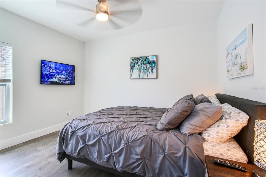 3040 Belcher Road Dunedin, FL 34698 - Photo 18 of 24 a bed sitting in a bedroom next to a window