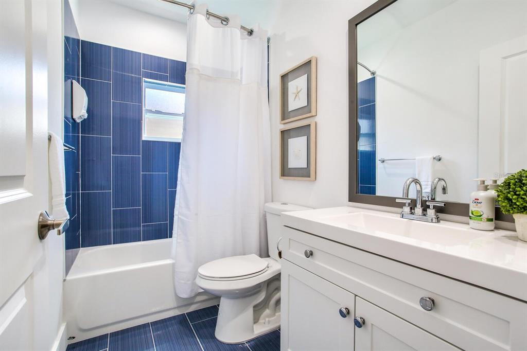 3040 Belcher Road Dunedin, FL 34698 - Photo 20 of 24 a bathroom with a sink a toilet and shower