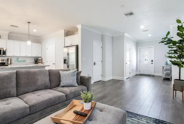 a living room with furniture and wooden floor