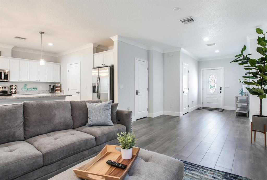 3040 Belcher Road Dunedin, FL 34698 - Photo 3 of 24 a living room with furniture and wooden floor