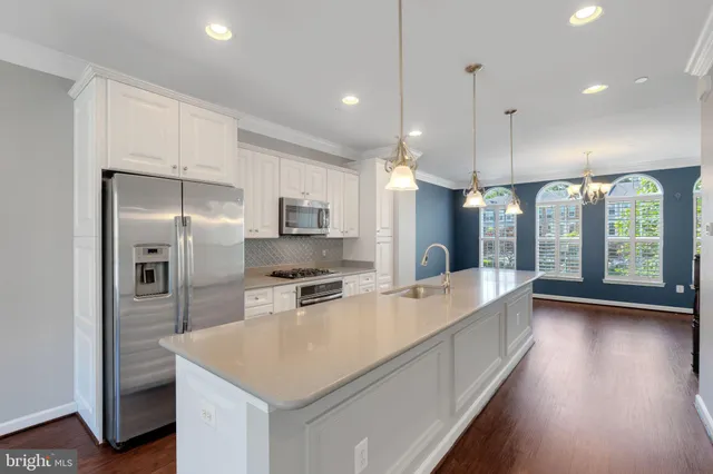 a view of livingroom with kitchen and hardwood
