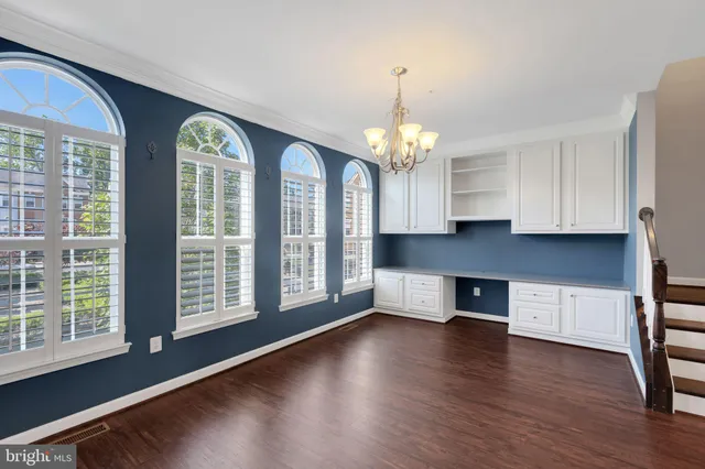 an empty room with wooden floor and fireplace