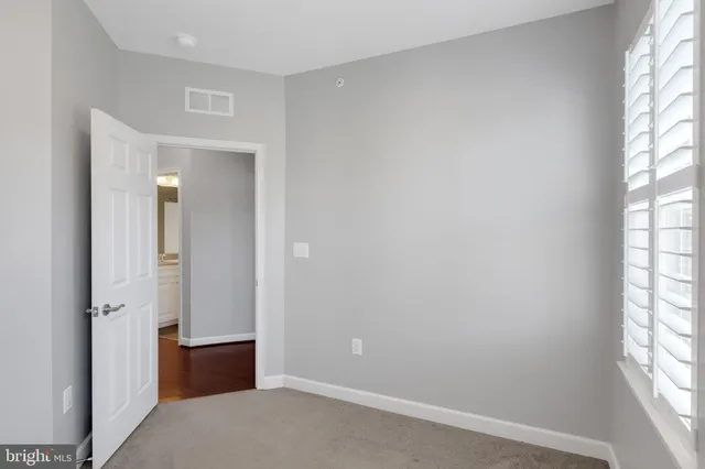 a view of a livingroom with a ceiling fan and window