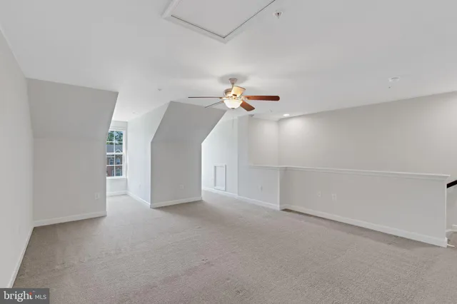 a view of a livingroom with a ceiling fan and window