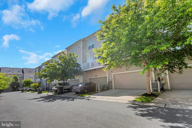 a view of a house with a yard and a street