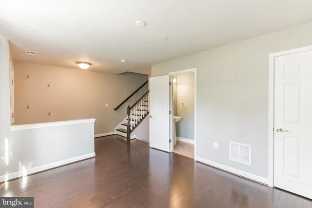 a large kitchen with kitchen island a large island a sink stainless steel appliances and wooden floor