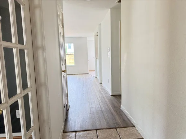 a view of a hallway with wooden floor