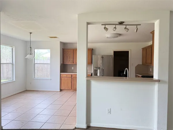 a view of a kitchen with a sink and a refrigerator