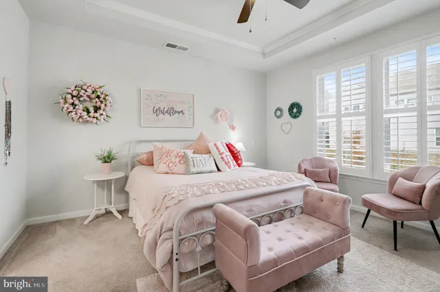 a bed room with a bed and a chair