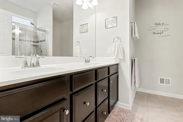 a bathroom with a double vanity sink and a mirror