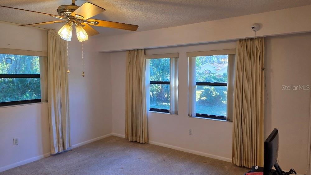 70 Furness Place Palm Coast, FL 32137 - Photo 11 of 30 a view of a livingroom with a ceiling fan and window