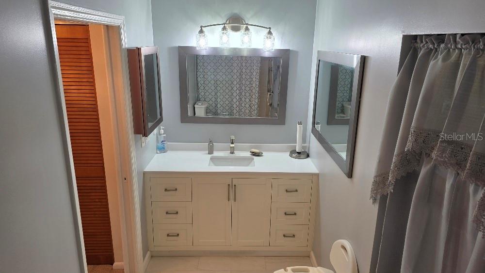 70 Furness Place Palm Coast, FL 32137 - Photo 16 of 30 a bathroom with double vanity and a mirror