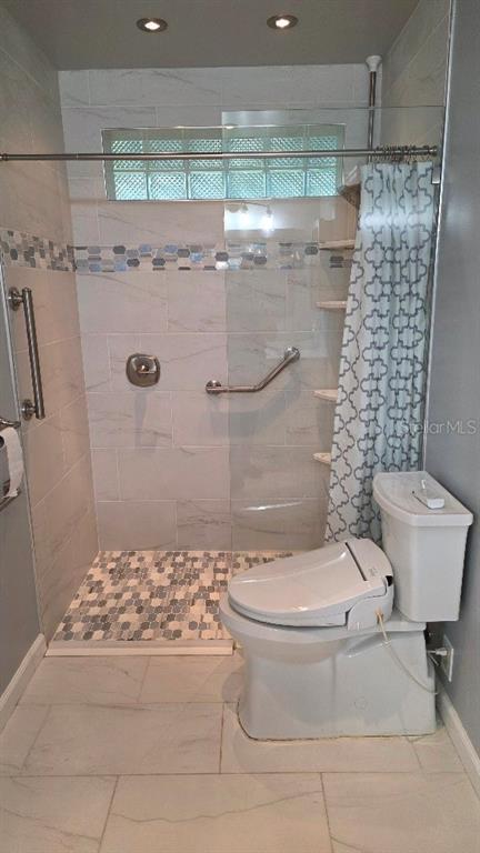 70 Furness Place Palm Coast, FL 32137 - Photo 17 of 30 a bathroom with a toilet and a shower