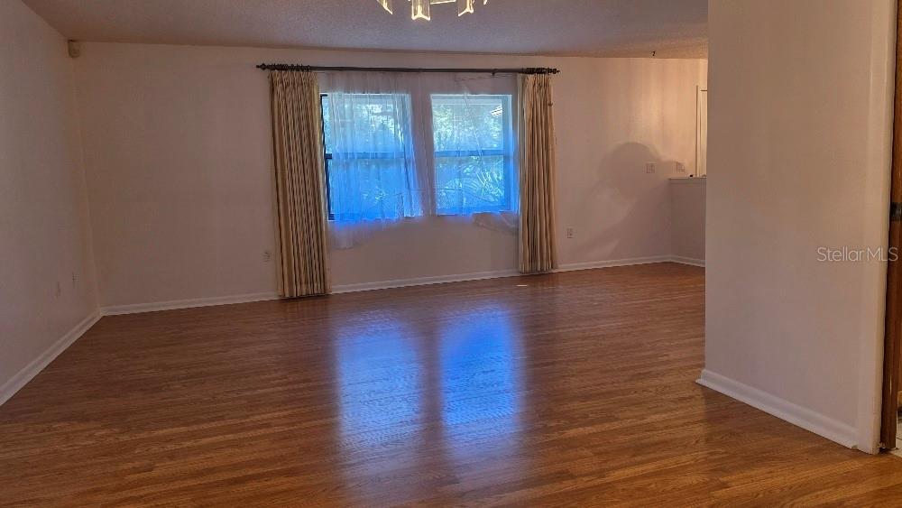 70 Furness Place Palm Coast, FL 32137 - Photo 19 of 30 a view of an empty room with wooden floor and a window