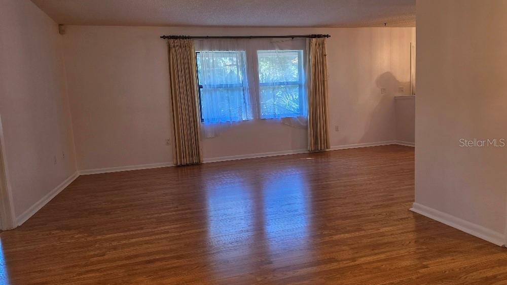 70 Furness Place Palm Coast, FL 32137 - Photo 20 of 30 an empty room with wooden floor and windows