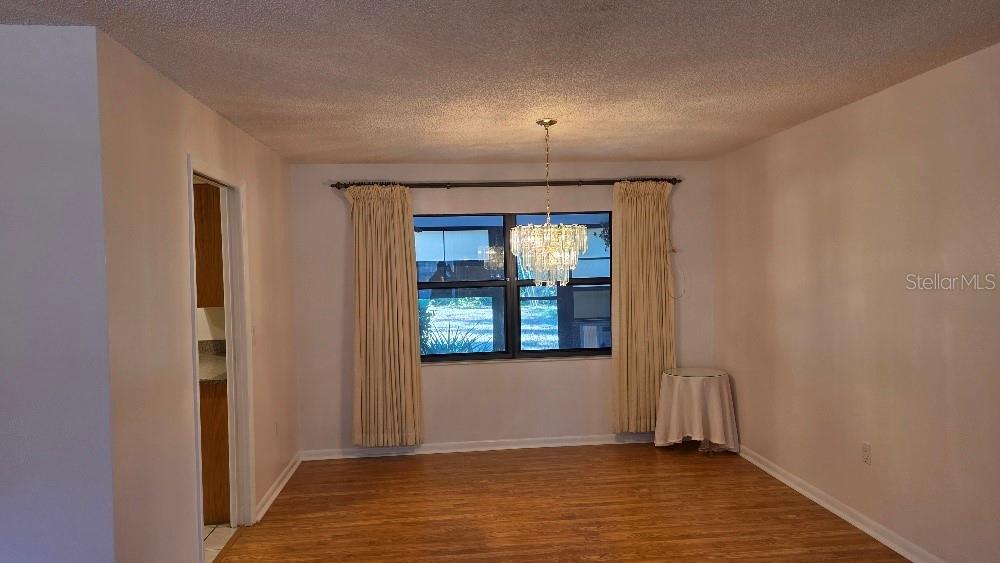 70 Furness Place Palm Coast, FL 32137 - Photo 21 of 30 an empty room with wooden floor and windows
