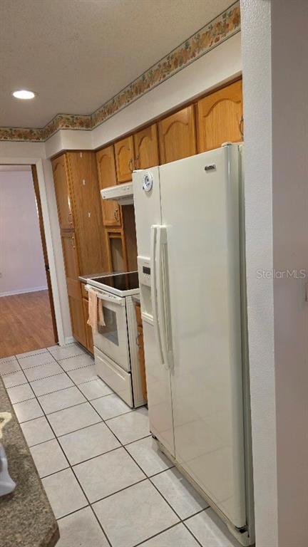 70 Furness Place Palm Coast, FL 32137 - Photo 22 of 30 a kitchen with stainless steel appliances a refrigerator and a stove top oven