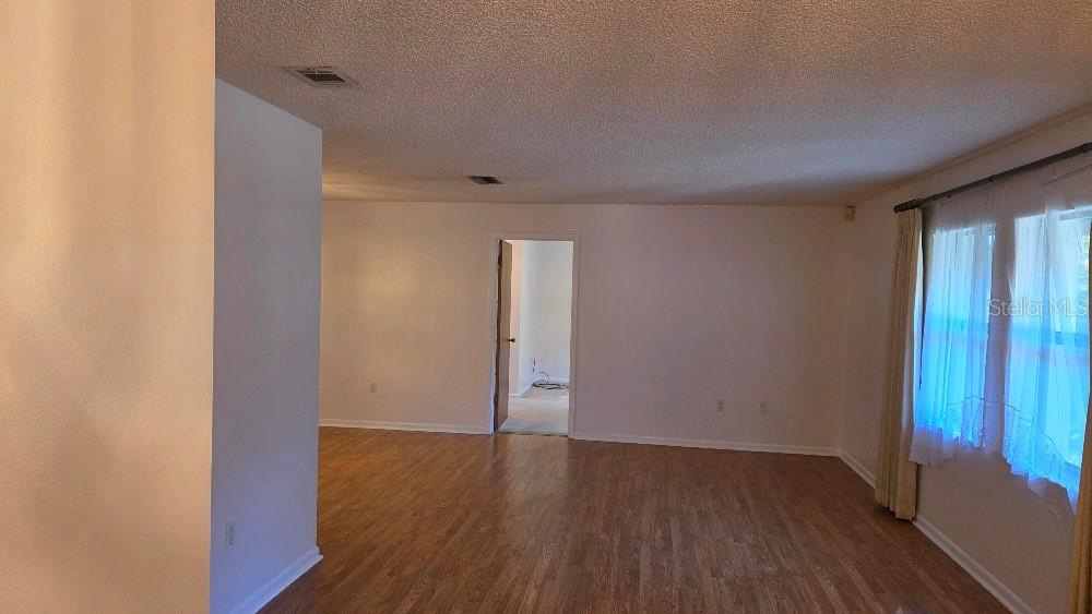 70 Furness Place Palm Coast, FL 32137 - Photo 8 of 30 an empty room with wooden floor and windows