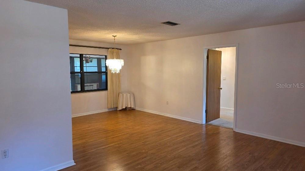 70 Furness Place Palm Coast, FL 32137 - Photo 9 of 30 a view of an empty room with wooden floor and a window