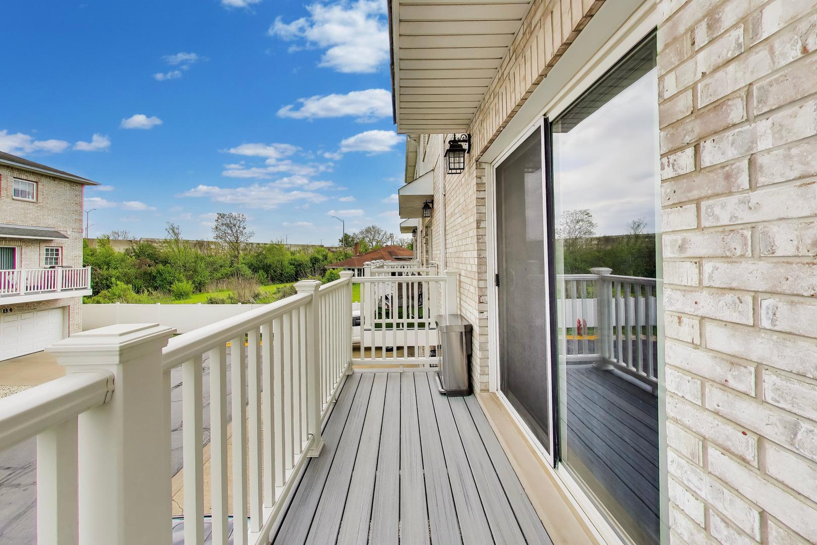 183 East River Road, Unit A3 Des Plaines, IL 60016 - Photo 13 of 21 a view of a balcony with wooden floor and fence
