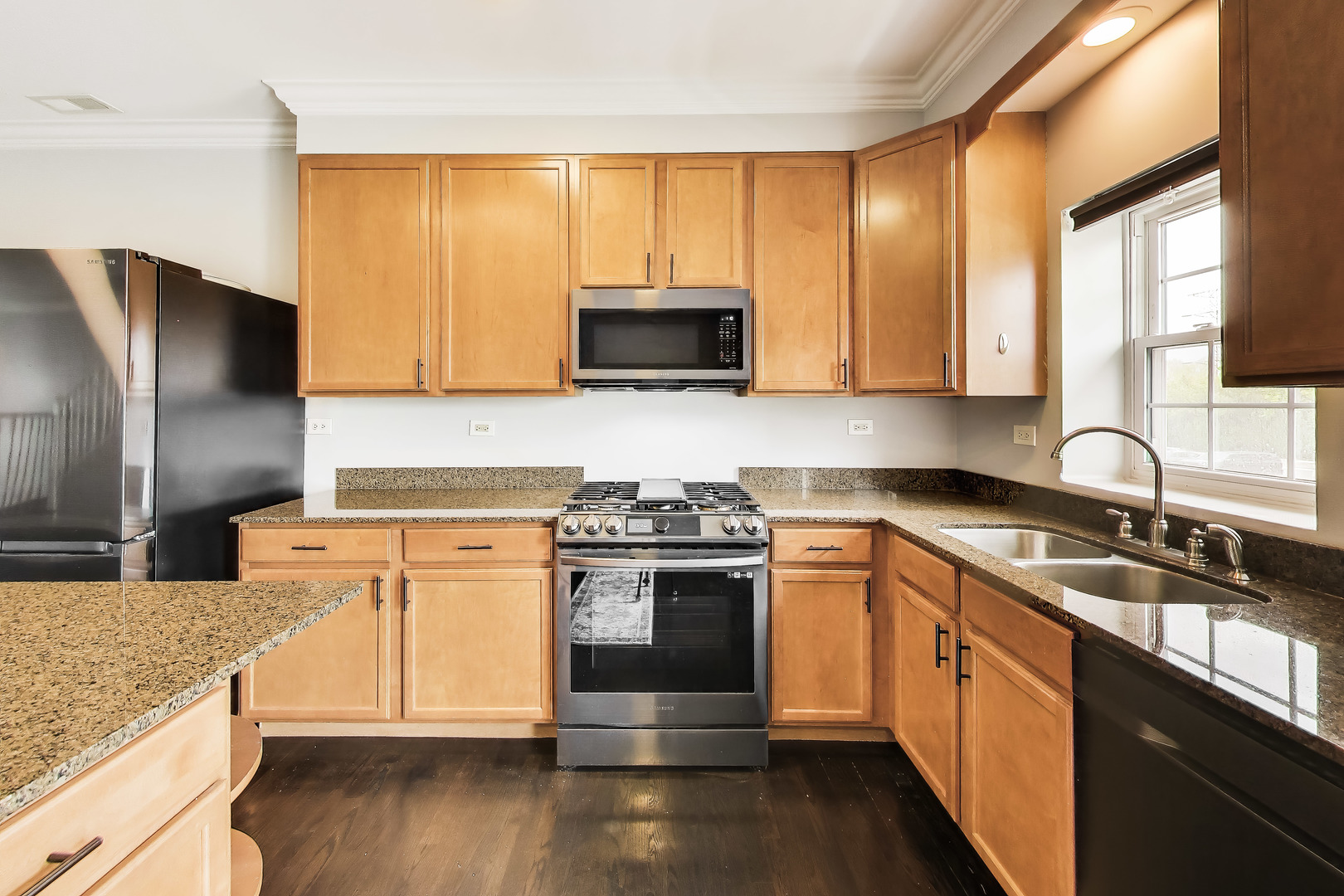 183 East River Road, Unit A3 Des Plaines, IL 60016 - Photo 6 of 21 a kitchen with stainless steel appliances granite countertop a stove a sink and a microwave