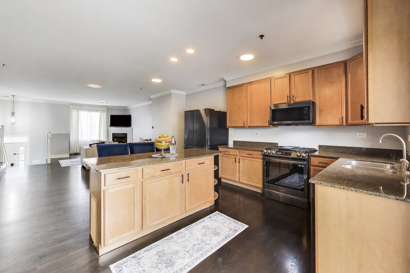 183 East River Road, Unit A3 Des Plaines, IL 60016 - Photo 7 of 21 a kitchen with stainless steel appliances granite countertop a stove top oven a sink a refrigerator and white cabinets with wooden floor