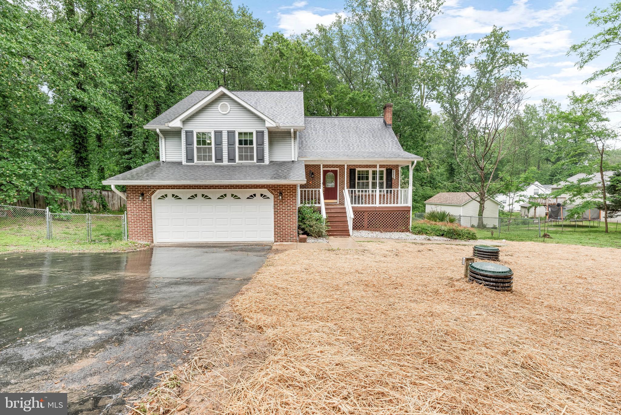 8328 Ridge View Road Lusby, MD 20657 - Photo 1 of 34 a front view of a house with a yard and garage