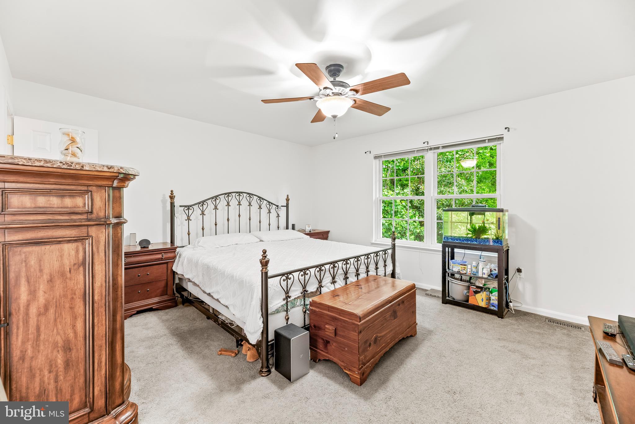 8328 Ridge View Road Lusby, MD 20657 - Photo 12 of 34 a bedroom with a bed and a chandelier