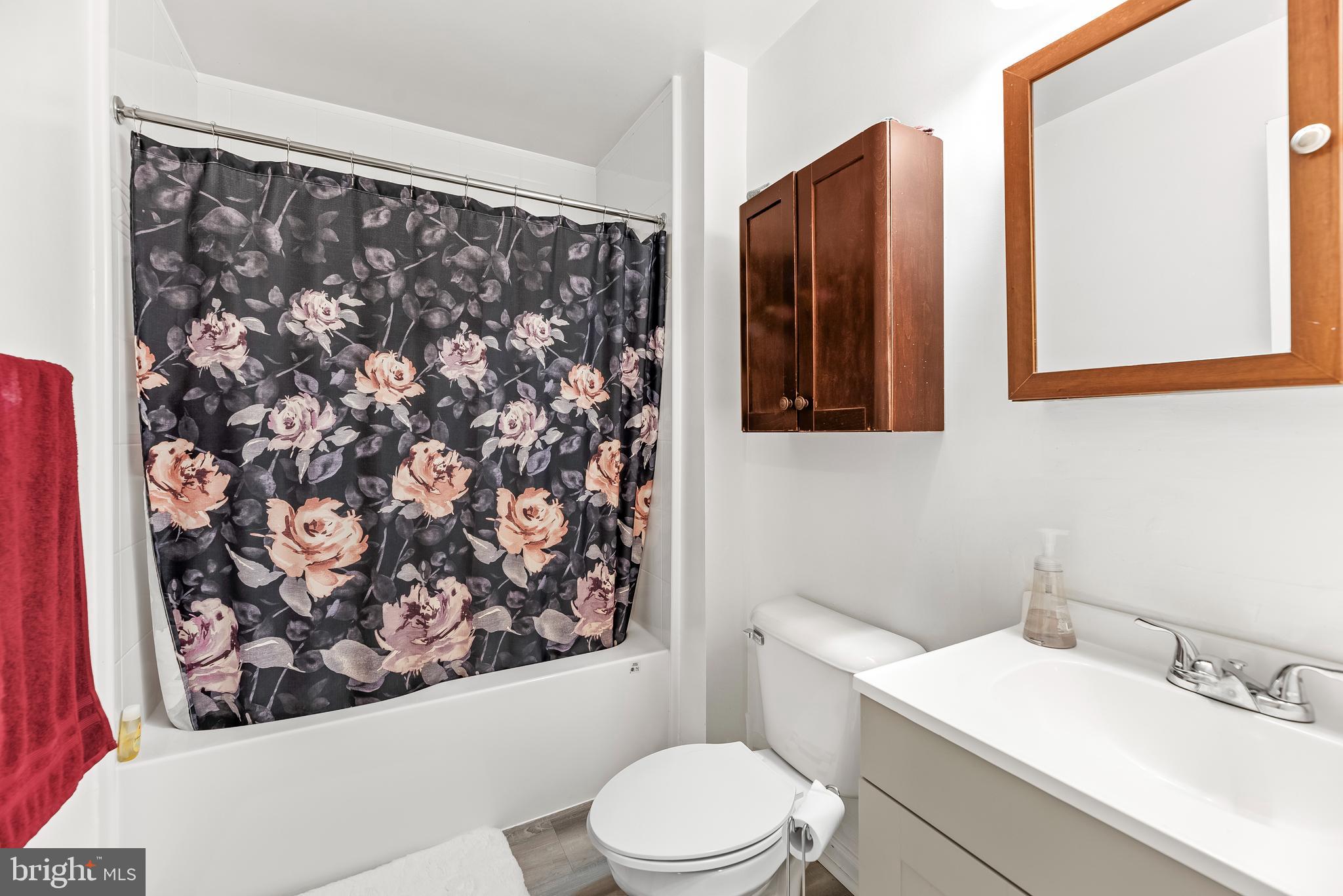 8328 Ridge View Road Lusby, MD 20657 - Photo 20 of 34 a bathroom with a toilet sink and mirror
