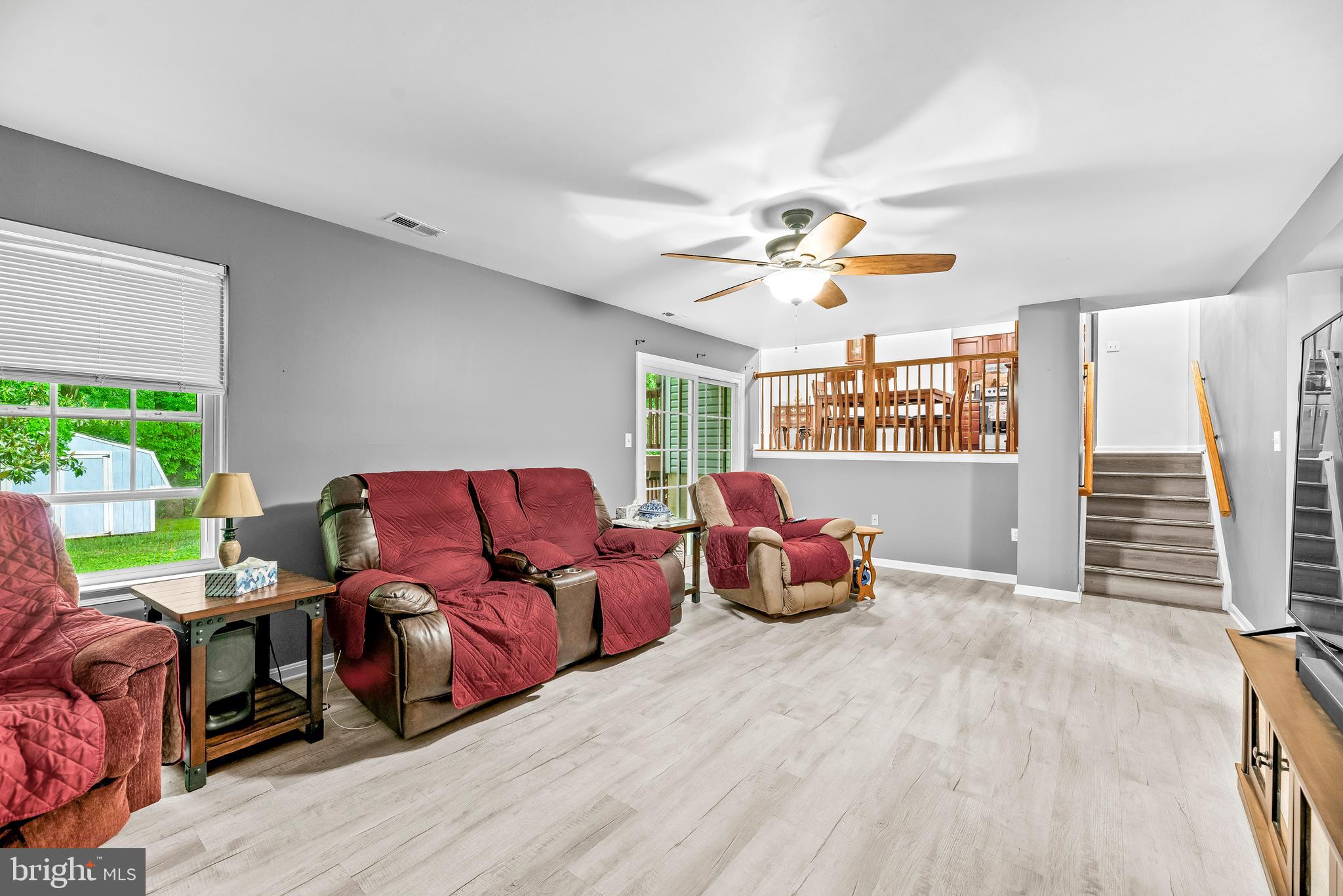 8328 Ridge View Road Lusby, MD 20657 - Photo 23 of 34 a living room with furniture and a chandelier