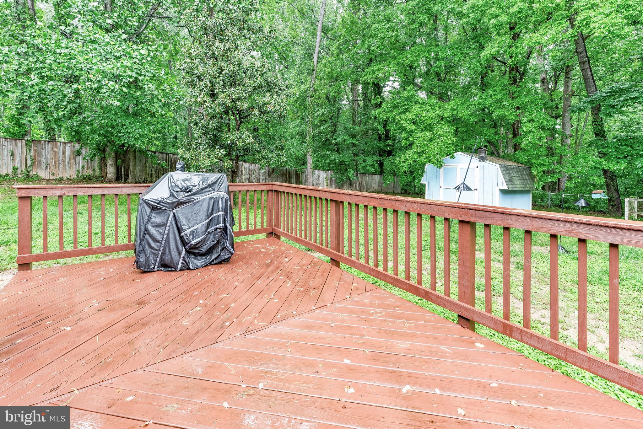 8328 Ridge View Road Lusby, MD 20657 - Photo 30 of 34 a view of a deck with a large window and wooden fence