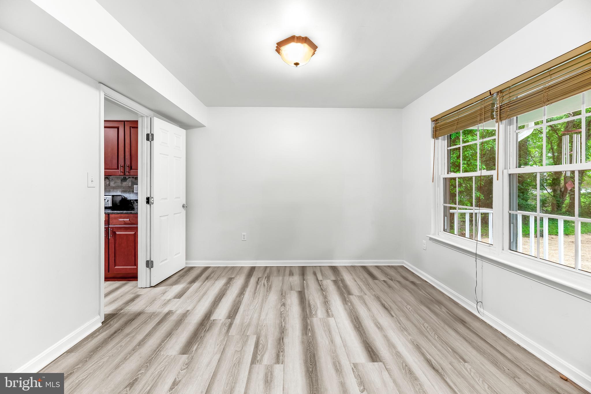 8328 Ridge View Road Lusby, MD 20657 - Photo 4 of 34 a view of a room with wooden floor and windows